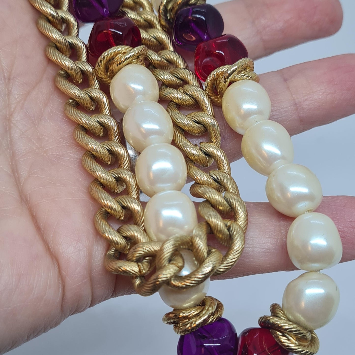 Vintage two-strand necklace with a gold-tone chain, plastic beads, and faux pearls.
