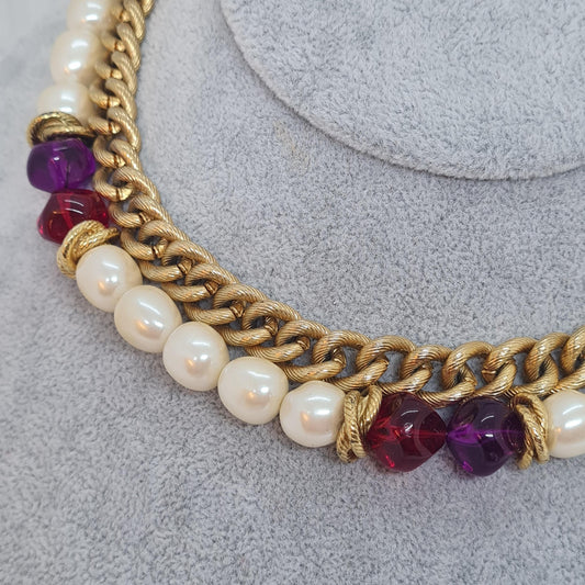Vintage two-strand necklace with a gold-tone chain, plastic beads, and faux pearls.